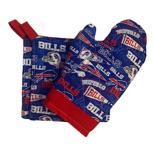 May include: Blue and red oven mitt and pot holder set with a Buffalo Bills logo pattern. The set features the team's logo, name, and mascot.