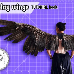 May include: A person wearing large, detailed cosplay wings with brown and black feathers. The wings are spread wide against a purple background with the text "Cosplay wings TUTORIAL book" at the top. A logo is in the lower left corner.