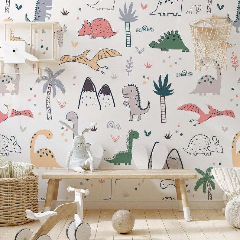 May include: A white wall mural with a repeating pattern of dinosaurs, palm trees, and mountains. The dinosaurs are drawn in a cartoon style and are in various colors, including green, pink, orange, and brown.