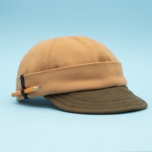 Docker beanie with short and soft brim. Limited edition cap made of cotton canvas. Docker cap with visor. Artistic hat with pencil holder.