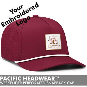 May include: A burgundy snapback cap with a white rope detail and a square patch featuring a tree logo. The cap has a perforated design on the side panels and the text "Your Embroidered Logo" is visible. The bottom of the cap reads "PACIFIC HEADWEAR WEEKENDER PERFORATED SNAPBACK CAP".