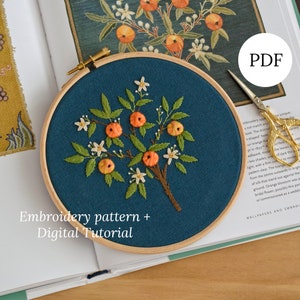 May include: Embroidery pattern and digital tutorial for a hoop art project featuring a small orange tree with white blossoms and green leaves on a teal background. The text "Embroidery pattern + Digital Tutorial" is at the bottom of the image.