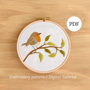 May include: Embroidery pattern and digital tutorial for a robin on a branch with green leaves. The pattern is in a hoop and the PDF text is visible in the top right corner.