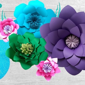 May include: A set of five paper flowers in various colors, including teal, purple, pink, and green. The flowers are arranged on a white wooden background.