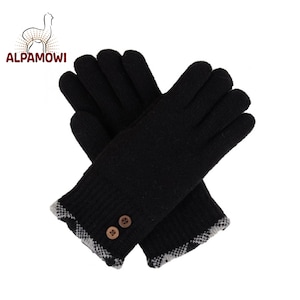 May include: A pair of black knit gloves with a white and black plaid trim. The gloves have two brown buttons on the cuff.