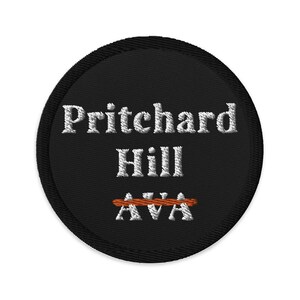 May include: Black round patch with white embroidered text that reads "Pritchard Hill AVA" with a red line through the "AVA".