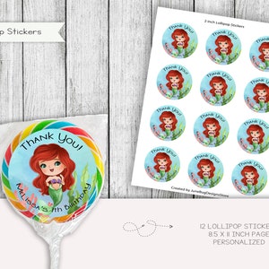May include: Twelve 2-inch round lollipop stickers featuring a cartoon mermaid with red hair holding a seashell. The stickers have a blue background with a white border and the text "Thank You!" in black. The stickers are printed on 8.5 x 11 inch sheets.