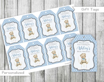 May include: Blue and white gift tags with a teddy bear sitting on a crescent moon. The tags say "Thank you for coming to Ashley's Baby Shower".