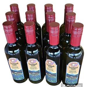 May include: Ten glass bottles of extra virgin olive oil from SunHawk Farms. The bottles are labeled with a red and black logo and the text "SunHawk Farms Extra Virgin Olive Oil Mendocino Grown".