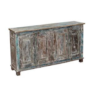 May include: A long, rectangular wooden cabinet with four doors. The cabinet has a distressed finish with shades of blue, brown, and white. The top of the cabinet is a lighter shade of brown. The cabinet is supported by short, rectangular feet.