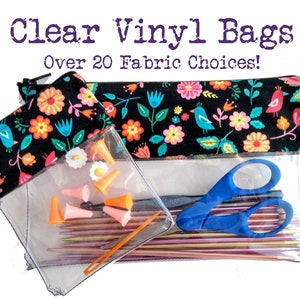 May include: Two clear vinyl bags with zippers. The smaller bag is filled with knitting needles and stitch markers. The larger bag is filled with knitting needles, scissors, and a crochet hook. Both bags have a black fabric lining with a colorful floral pattern and the text "Clear Vinyl Bags Over 20 Fabric Choices!"