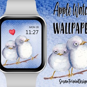 May include: Apple Watch wallpaper featuring two watercolor painted birds perched on a branch. The birds are light blue and white with large eyes. The background is a light blue watercolor wash. The watch face shows the time 11:27 and the date MON 28. The text "Apple Watch WALLPAPER" is at the top of the image. The text "Susan Turpin Design" is at the bottom of the image.