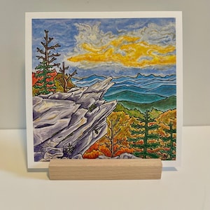 May include: A colorful illustration of a mountain landscape with a rocky cliff, trees, and a yellow cloud in the sky. The scene is painted in a cartoon style with bright colors.
