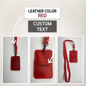 May include: Red leather ID badge holder with a detachable lanyard. The holder has a pocket for a card and the text "Deputy" is engraved on the front.