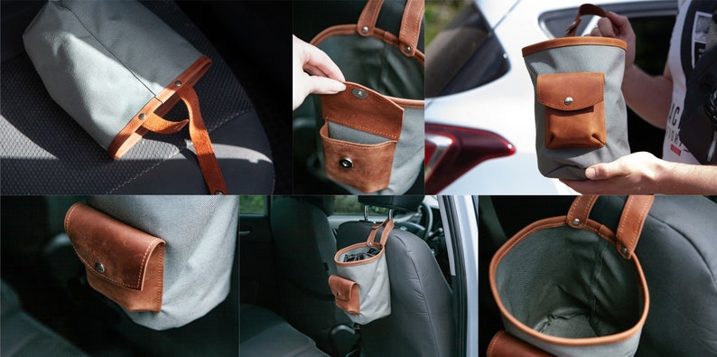 Op de afbeelding: Een grijze canvas tas met een bruin leren zakje en handvat. De tas hangt aan de hoofdsteun van een autostoel.