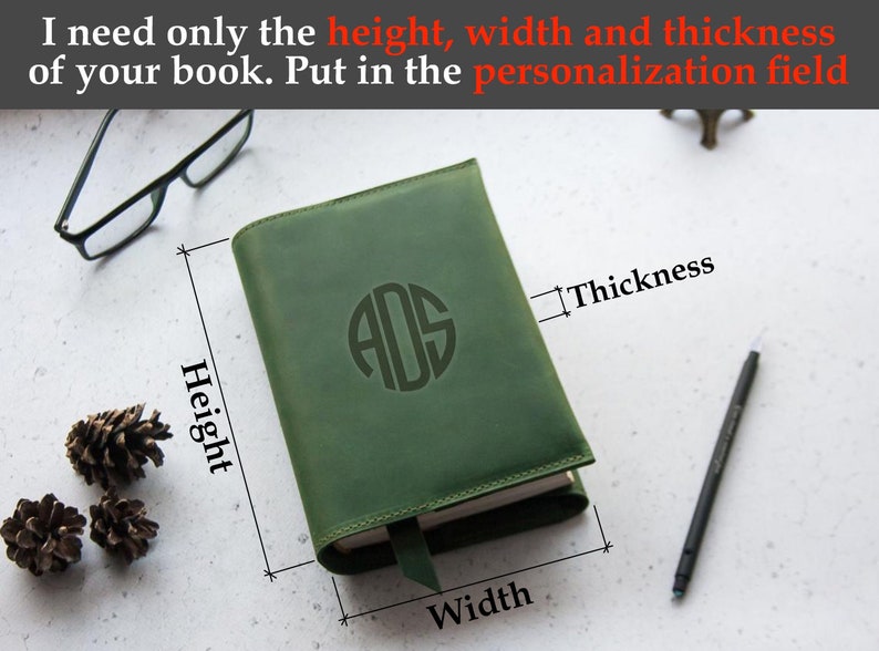 May include: A green leather-bound journal with a monogrammed initial "ADS" on the front cover. The journal is closed and the dimensions are labeled: height, width, and thickness.