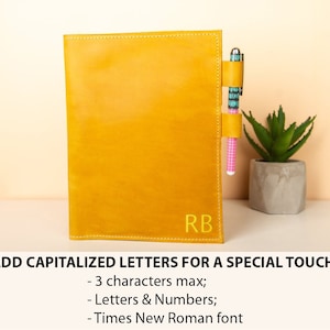 May include: A yellow leather journal with a pen holder and the initials "RB" embossed on the front. Add a personalized touch with up to 3 capitalized letters or numbers in Times New Roman font.