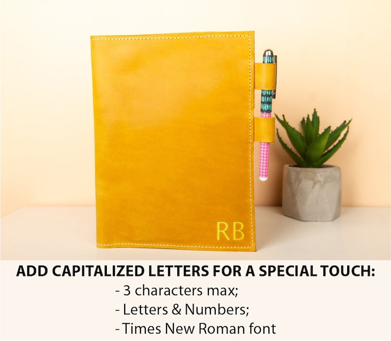 May include: A yellow leather journal with a pen holder and the initials "RB" embossed on the front. Add a personalized touch with up to 3 capitalized letters or numbers in Times New Roman font.