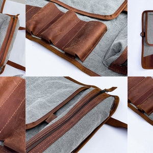 May include: A gray canvas and brown leather roll-up knife case with multiple slots for knives and a zippered pouch. The case has a strap for carrying.