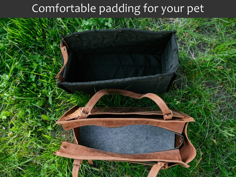 May include: Two pet carriers are shown on grass. The top carrier is black with a quilted interior. The bottom carrier is brown leather with a grey interior. The text "Comfortable padding for your pet" is at the top.