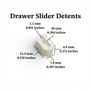 May include: A white drawer slider detent with a central slot. The component measures 0.051 inches by 0.394 inches for the slot, with overall dimensions of 0.528 inches in length, 0.307 inches in width, and 0.272 inches in height.