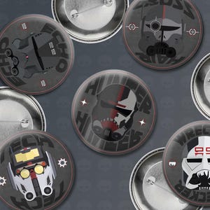 May include: Set of ten 1-inch diameter round pinback buttons featuring characters from the Star Wars: The Bad Batch animated series. The buttons feature the characters Echo, Hunter, Wrecker, and Tech. Each button has a black and white design with red accents.