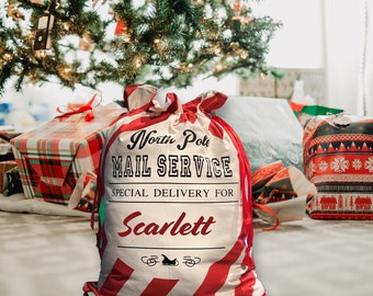 May include: A red and white striped Santa sack with the text "North Pole Mail Service" and "Special Delivery for Scarlett".