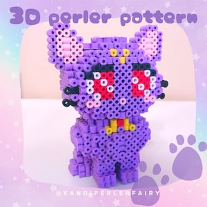 May include: A 3D perler bead pattern of a purple cartoon character with red eyes and a yellow collar. The pattern is titled "3D perler pattern" and is created by @KANDIPERLERFAIRY.