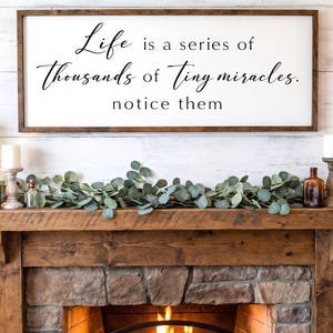 May include: A framed sign with the quote "Life is a series of thousands of tiny miracles. notice them" in black script. The sign hangs above a rustic wooden mantel decorated with candles, greenery, and bottles. The text "FULLY CUSTOMIZABLE - SIZES, COLORS" is at the bottom.