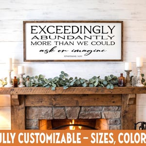 May include: A rectangular wooden sign with the text "EXCEEDINGLY ABUNDANTLY MORE THAN WE COULD ask or imagine" in black lettering. The sign is above a fireplace mantel decorated with candles, greenery, and bottles. The bottom of the image reads "FULLY CUSTOMIZABLE - SIZES, COLORS."