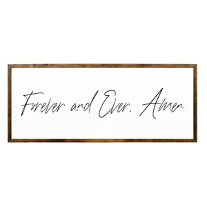 May include: A framed wood sign with the text "Forever and Ever. Amen" in black cursive script on a white background.