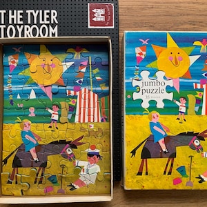 May include: A vintage children's puzzle with a colourful illustration of a circus scene, featuring a sun, kites, and figures riding donkeys. The puzzle is in its original box, labelled "Jumbo Puzzle" with 35 pieces.