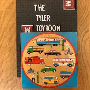 May include: A wooden puzzle depicting a circular city street scene with a variety of vehicles, including a bus, a truck, a car, a motorcycle, and a bicycle. The puzzle pieces are colourful and have a vintage style. The puzzle is made by Simplex Toys.