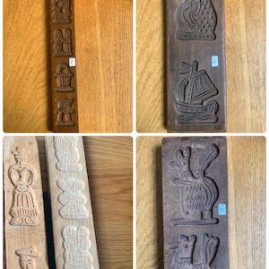 Op de afbeelding: Set van zes vintage houten koekjesvormen met verschillende ontwerpen, waaronder een zeemeermin, een schip, een haan, een eekhoorn en twee andere figuren. De vormen zijn gemaakt van donkerbruin hout en hebben ingewikkelde details.