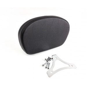 May include: A black, oval-shaped motorcycle backrest with a smooth surface. Includes a chrome-colored mounting bracket and several silver bolts. The backrest is designed to provide support and comfort for the rider.