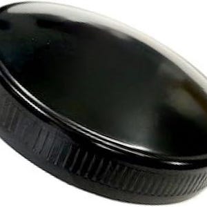 May include: A black plastic bottle cap with a ridged edge.