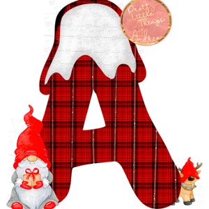 May include: Red and black plaid letter A with a white snowy top. A gnome with a red hat and a reindeer are on either side of the letter. The text "Pretty Little Things by Andrea" is in a pink circle at the top of the image.