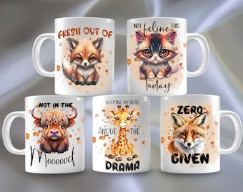 May include: Set of five white ceramic mugs with colorful animal illustrations and humorous text. The mugs feature a fox, a cat, a cow, a giraffe, and a fox. The text on the mugs reads "Fresh out of", "Not feline this today", "Not in the mood", "Keeping my head above the drama", and "Zero given".