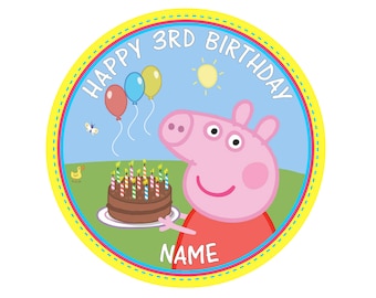 May include: A circular graphic with the text "HAPPY 3RD BIRTHDAY" and the name field. The image features a cartoon pig holding a chocolate cake with lit candles. Balloons, a sun, a butterfly, and a duck are also present.