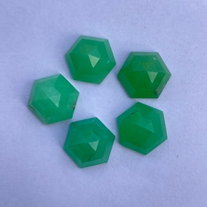 May include: Five green gemstone cabochons, each cut into a hexagonal shape with a faceted top.