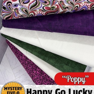 May include: A stack of fabric bundles in various colors and patterns. The top fabric features a white background with a paisley design in purple, red, green, and black. Other fabrics are solid purple, white, green, and patterned purple. The text "Poppy" is on a red banner.