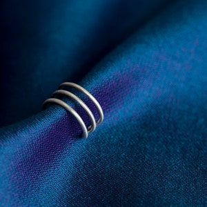 Triple hooped ear cuff with a brush matte texture / mirror finish. Contemporary, minimalist, sleek! Adjustable, no piercing needed!