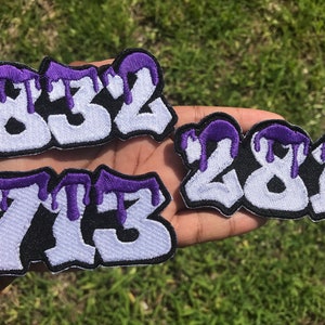 May include: Three embroidered patches with white numbers and a purple dripping paint effect. The numbers are 832, 281, and 713.