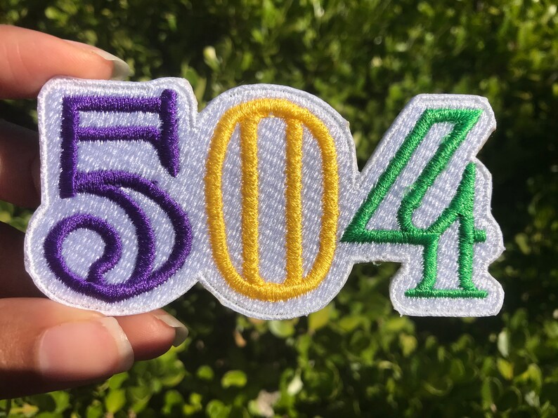 May include: Purple, yellow, and green embroidered patch with the numbers "504" on a white background.