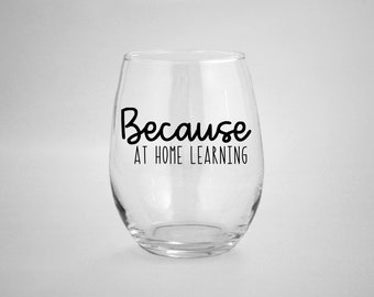 May include: A clear glass wine glass with the text "Because at home learning" printed on the side.