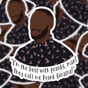 May include: A sticker featuring a cartoon illustration of a man with a beard wearing a dark blue shirt with a pink bird pattern. The text "I'm the best with pranks, man! They call me Prank Sinatra!" is written below the image.