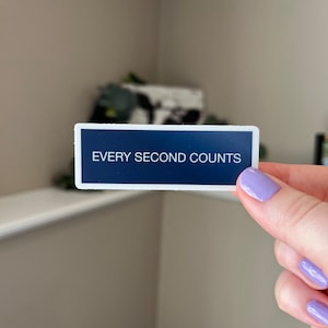 May include: A white sticker with a dark blue background and the text "EVERY SECOND COUNTS" in white.