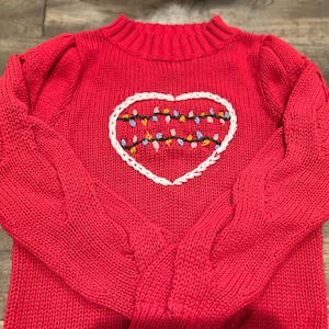 Red knit sweater with hand embroidered Christmas lights in a heart. size: 8-10