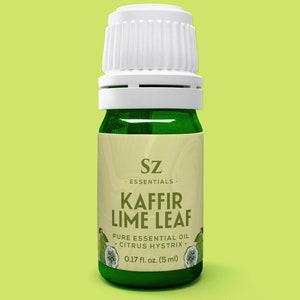 May include: A small green glass bottle with a white cap, labeled "Sz Essentials. Kaffir Lime Leaf Pure Essential Oil Citrus Hystrix 0.17 fl. oz. (5 ml)"