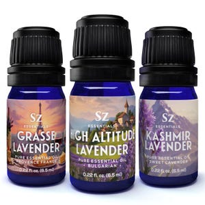 May include: Three small blue glass bottles with black lids containing essential oils. The bottles are labeled with the names "Grasse Lavender", "High Altitude Lavender", and "Kashmir Lavender". Each bottle contains 0.22 fluid ounces (6.5 ml) of oil.